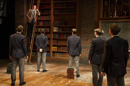 Jason Sudeikis (on ladder) in a scene from “Dead Poets Society” (Photo credit: Joan Marcus)