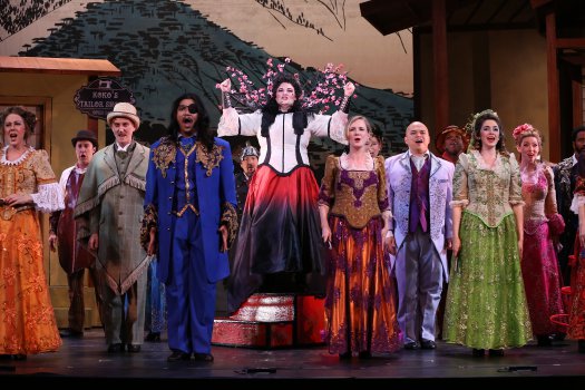 Cáitlín Burke as Katisha and company in the first act finale of New York Gilbert & Sullivan Players’ new production of “The Mikado” (Photo credit: Carol Rosegg)